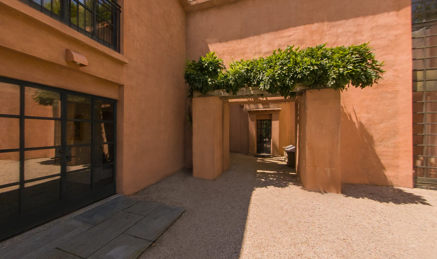 Courtyard of the Michael Graves residence with planted trellis overhead
