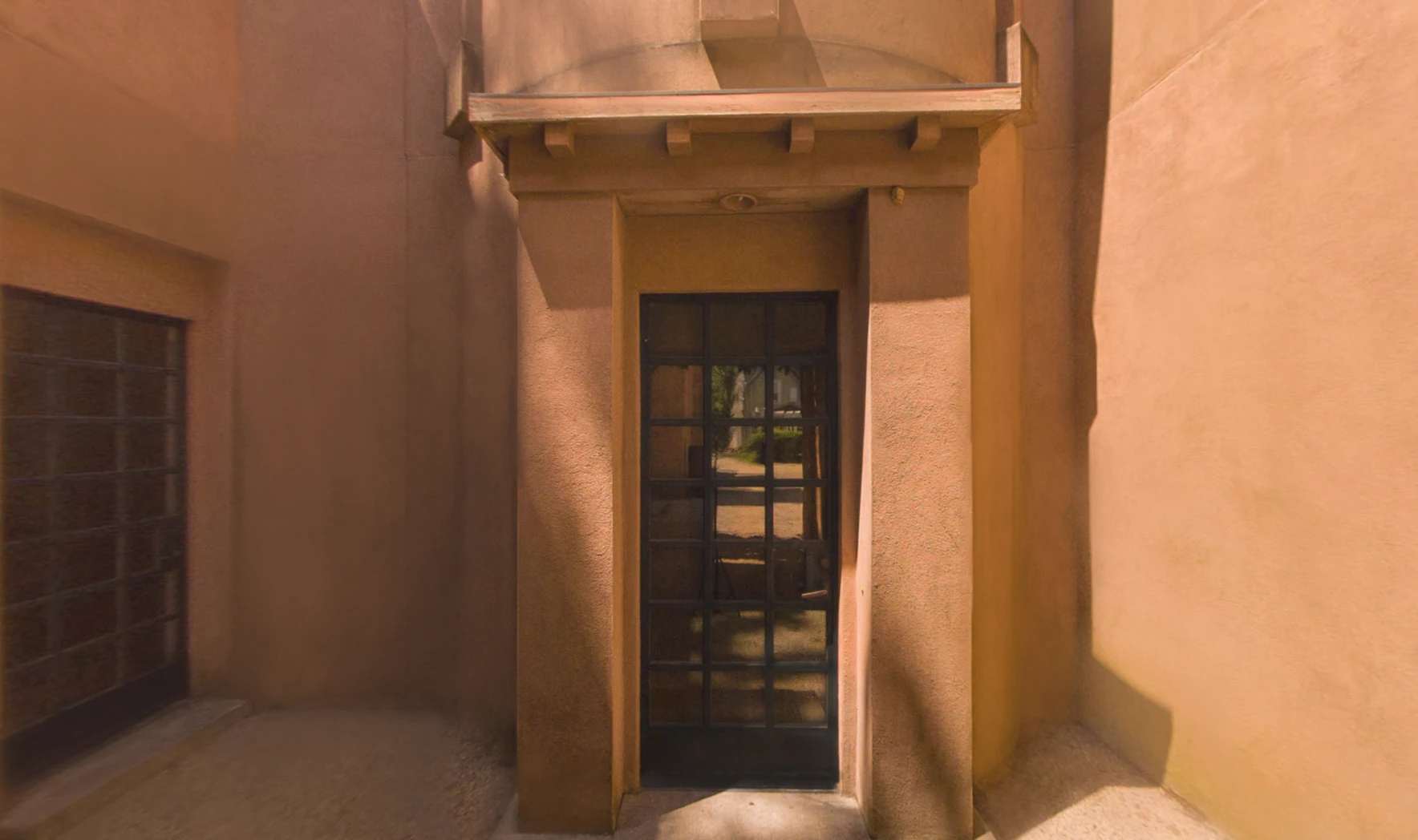 Entryway of the Michael Graves residence framed by a stucco portico