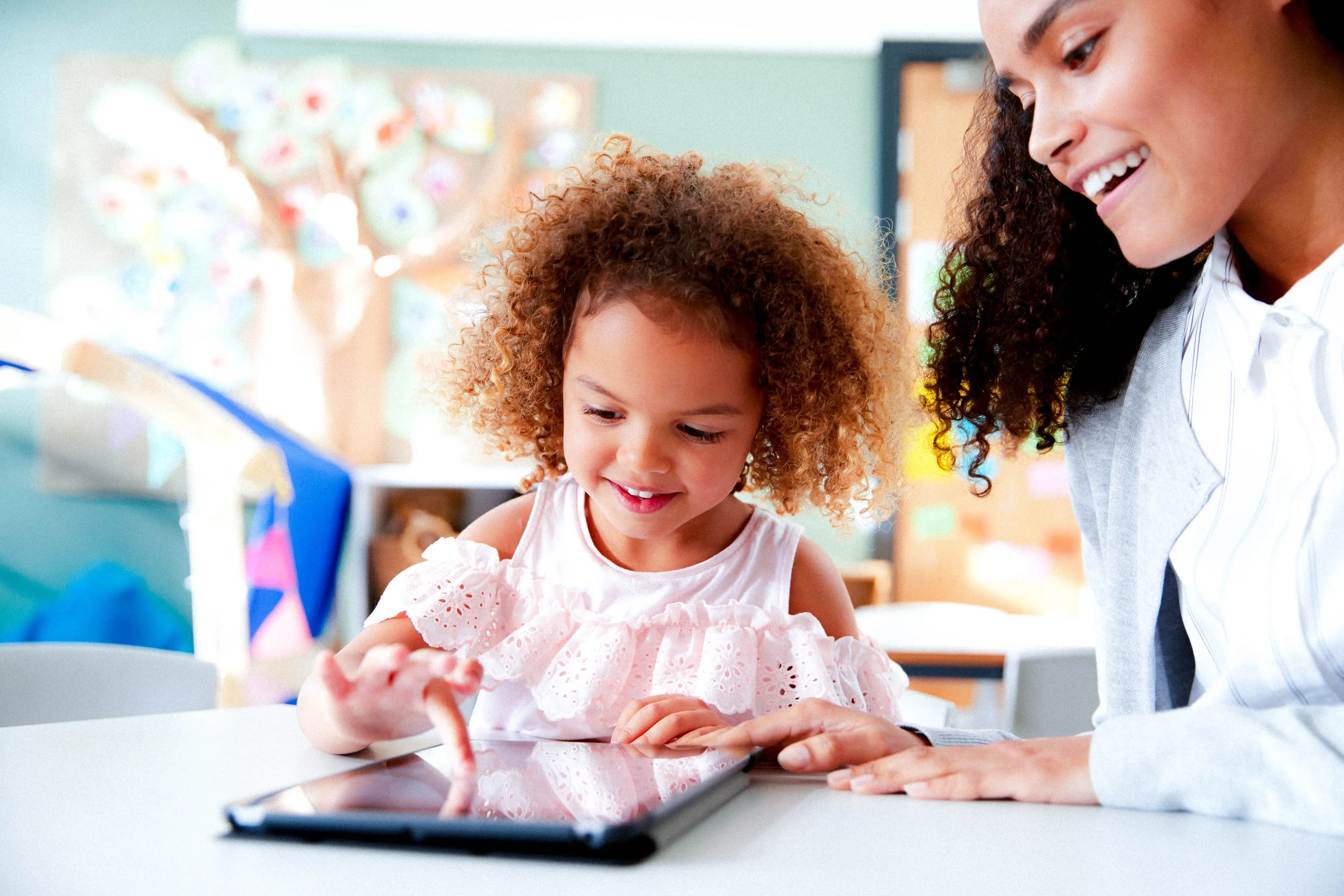 A parent and child using a tablet together